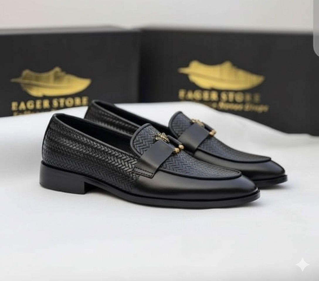 Black textured loafers with the signature bee accent.